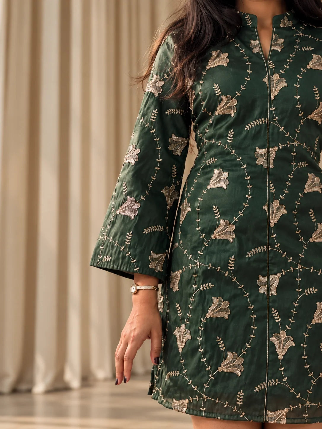 Close view of the mazo Ivy dress: band collar, V slit and hand finished aari embroidery with sequins on bottle green silk