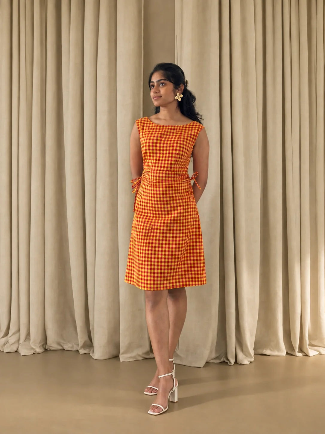 Summer Jam cotton midi dress for women in red and yellow gingham, worn with white heeled sandals, front view