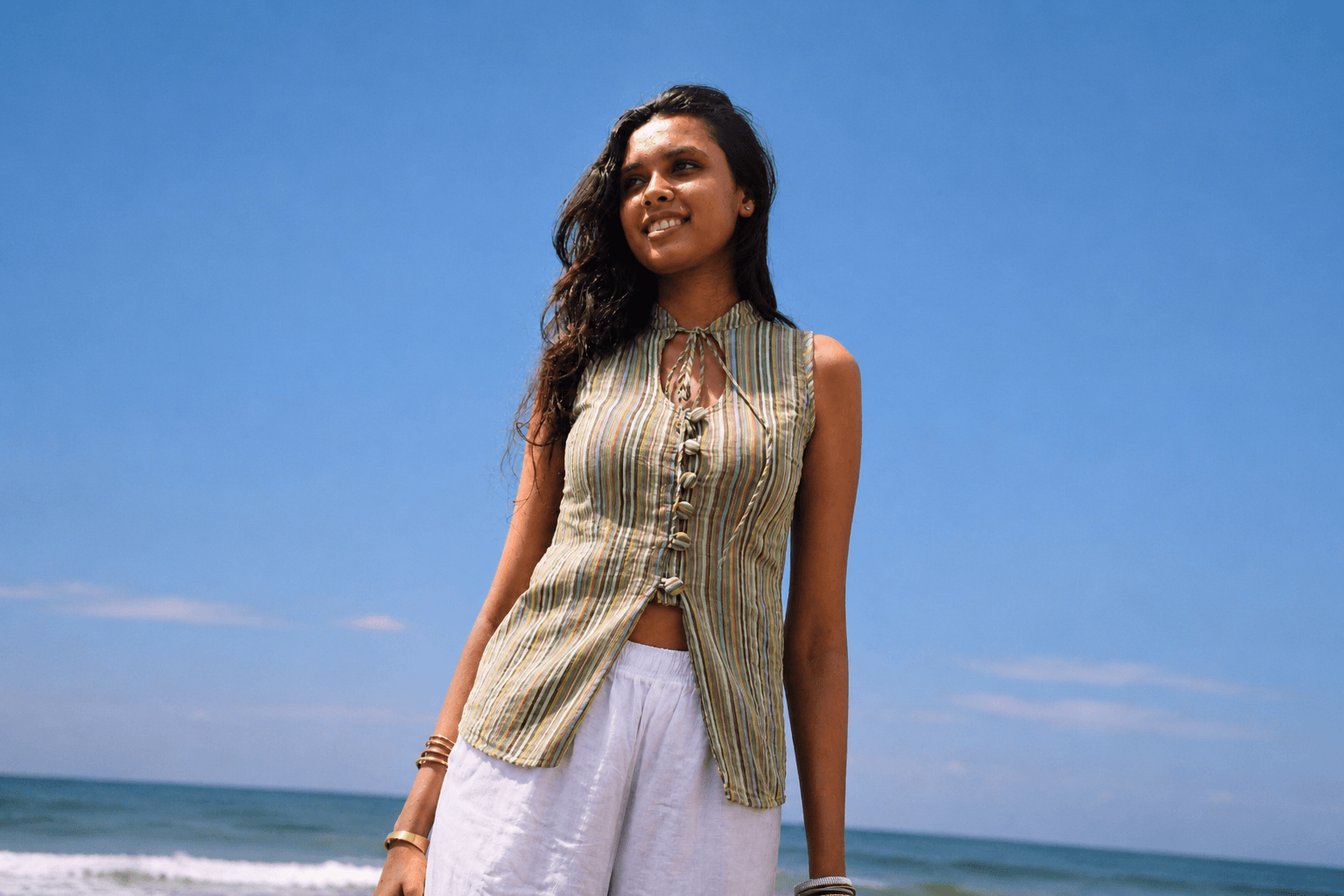 Women wearing green striped top by the beach