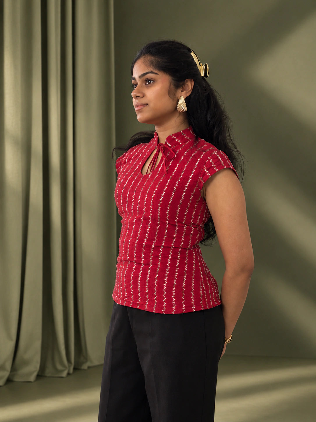mazo Mirchi top, side view with cap sleeves, worn with black wide leg trousers