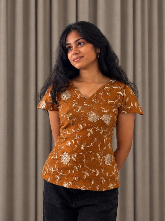 mazo Pataka rust embroidered peplum top for women, front view