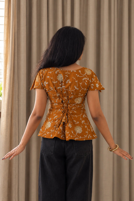 mazo Pataka top, back view of the lace up back and the peplum flare